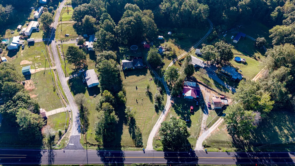 Top-down aerial of the road frontage and nearby homes